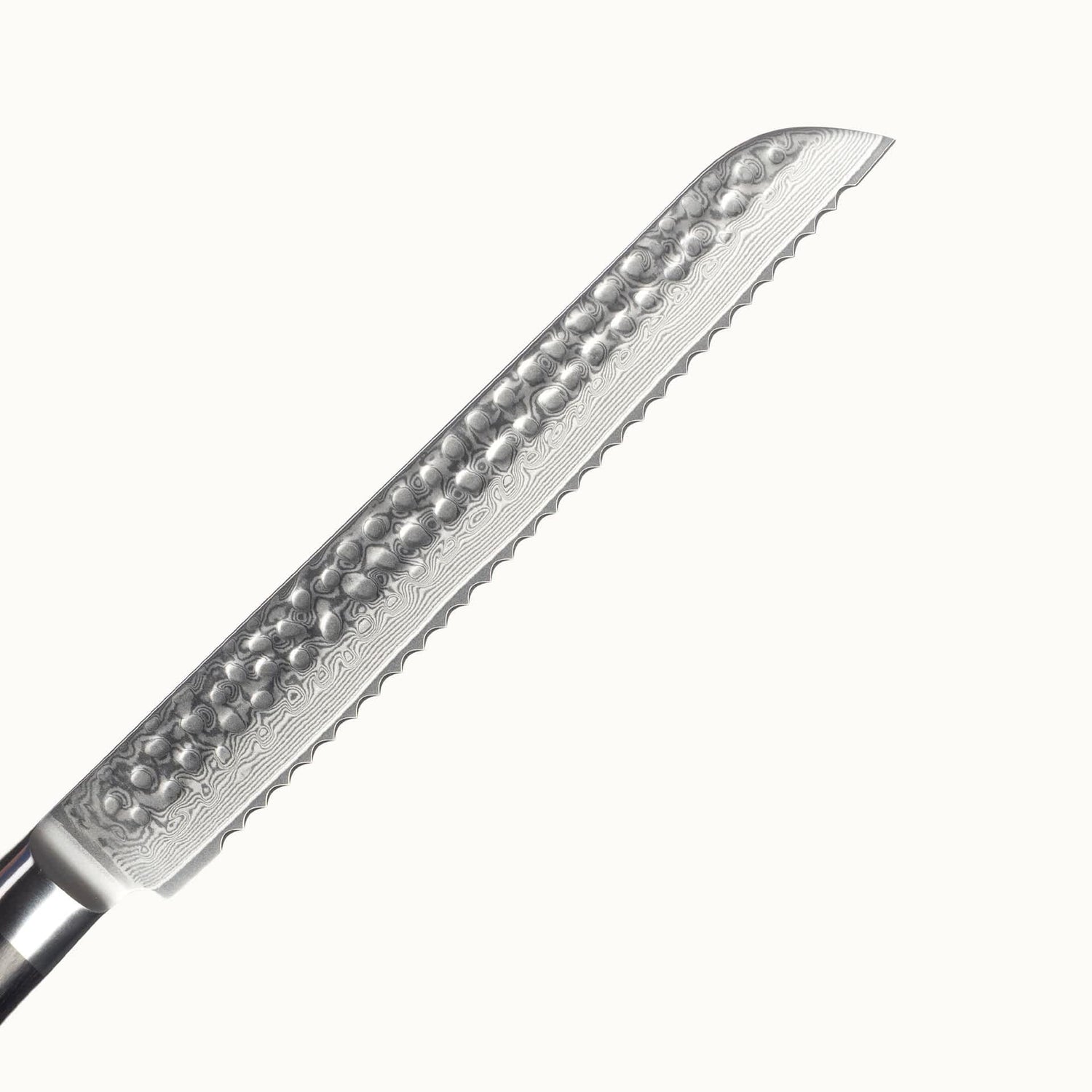 Nahaufnahme der Klinge aus Damaststahl mit Hammerschlag. Die wunderschöne Maserung aufgrund der Stahlschichten ist klar erkennbar.